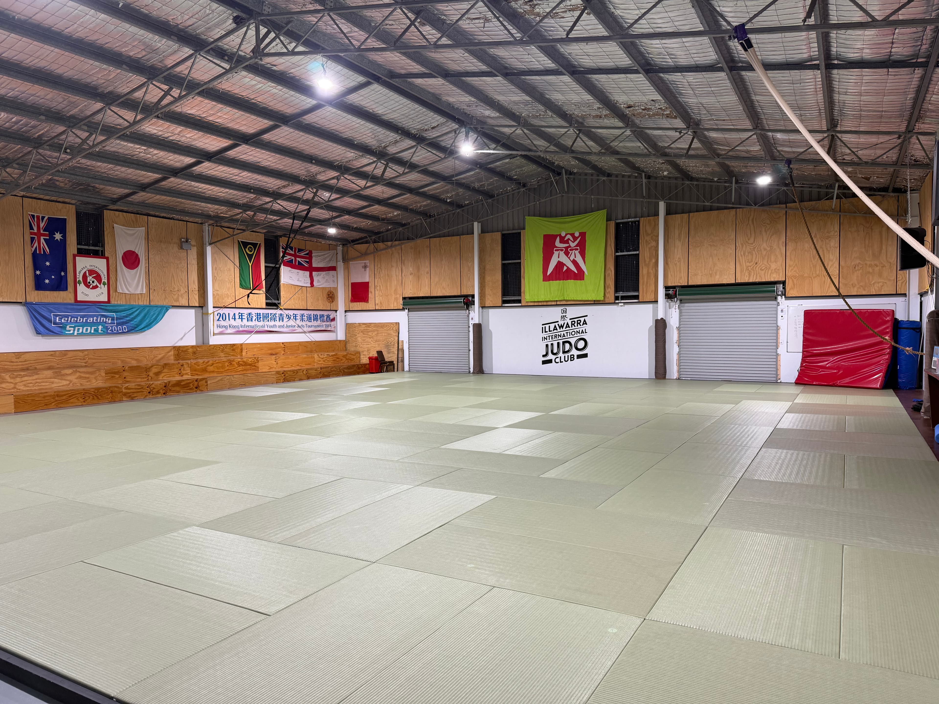 Inside the International Judo Centre showing flags and wooden walls