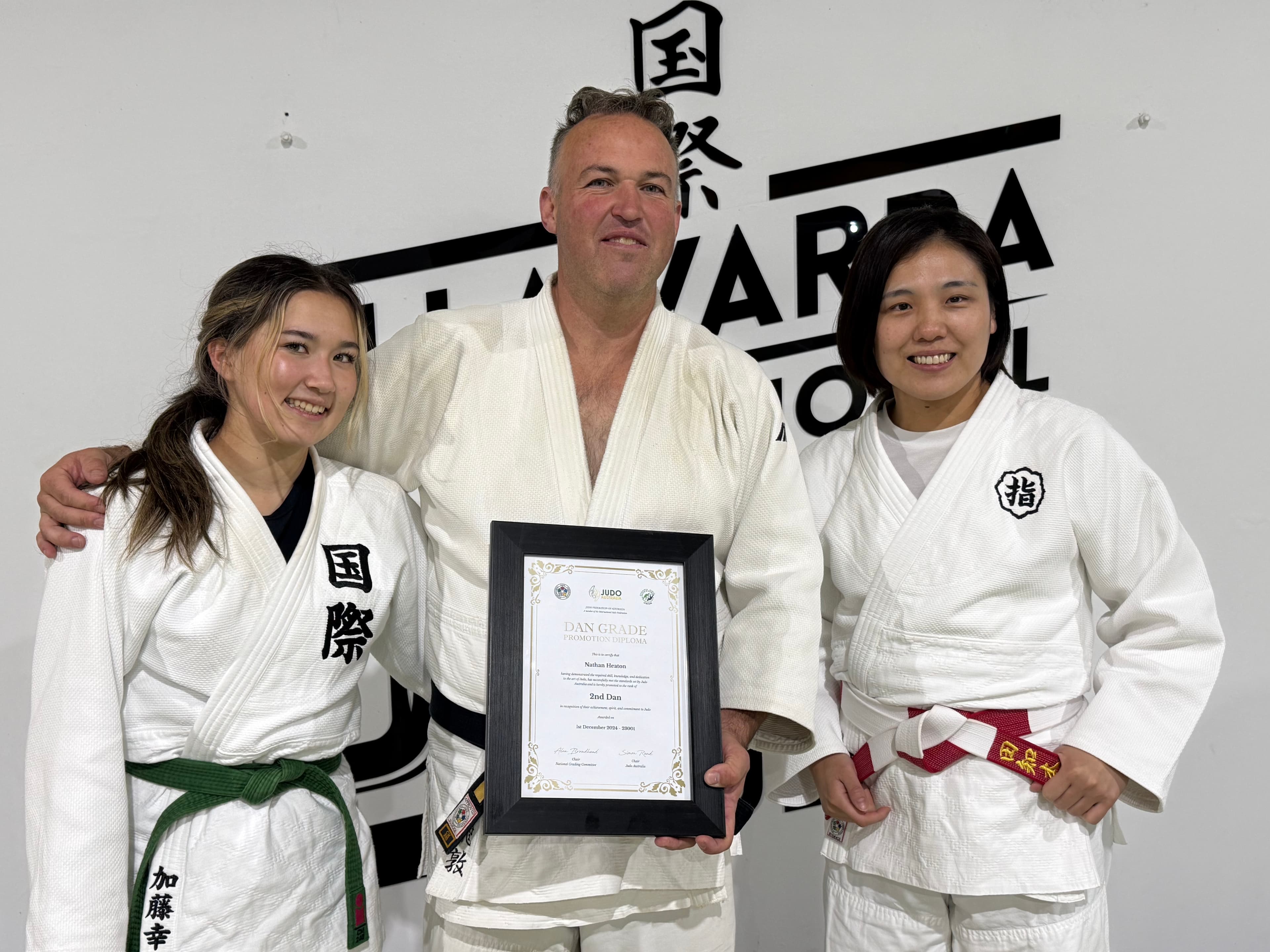 Rio 2016 Olympic champion presenting a dan grade certificate to an IIJC member at the club